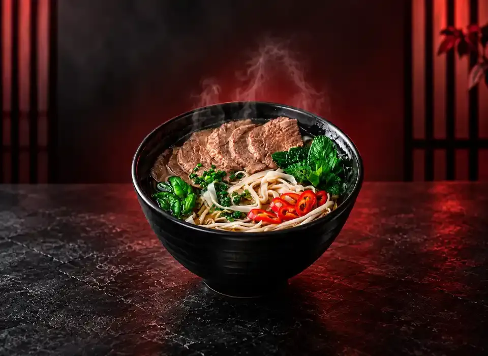 Our kitchen team preparing fresh dishes at Pho Que Huong Noodles and Grill Plano